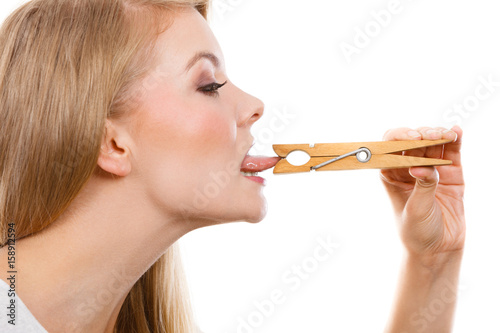 Quadro su tela Blonde woman having tongue in clothespin