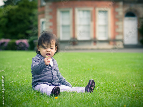 baby girl playing countryside on sunny day