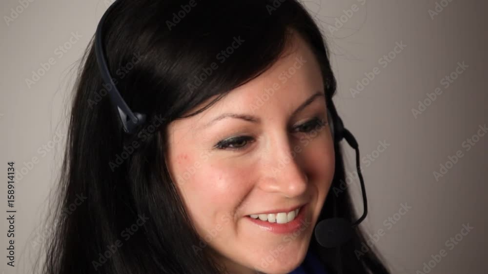 Attractive customer service representative talking on a headset. Attractive customer service representative talking on a headset.