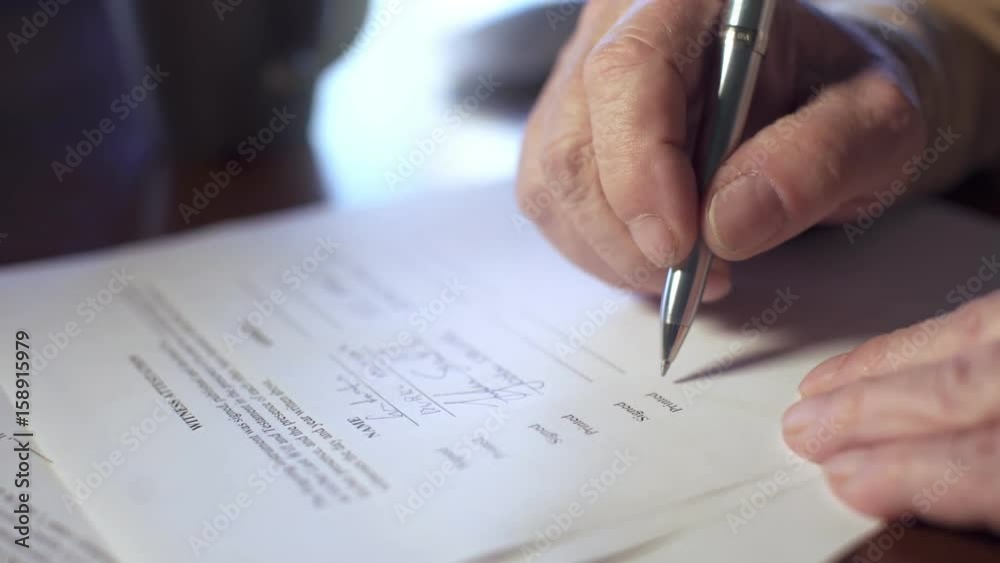 Confused senior man signing a legal document