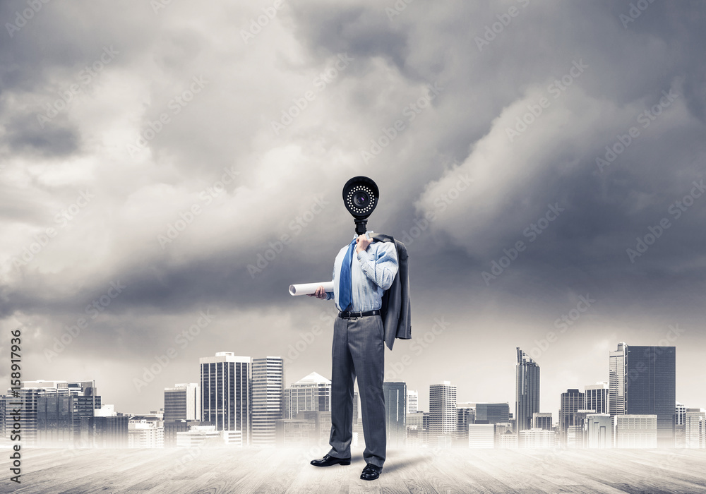 Camera headed man standing on wooden floor against modern citysc Camera headed man standing on wooden floor against modern citysc