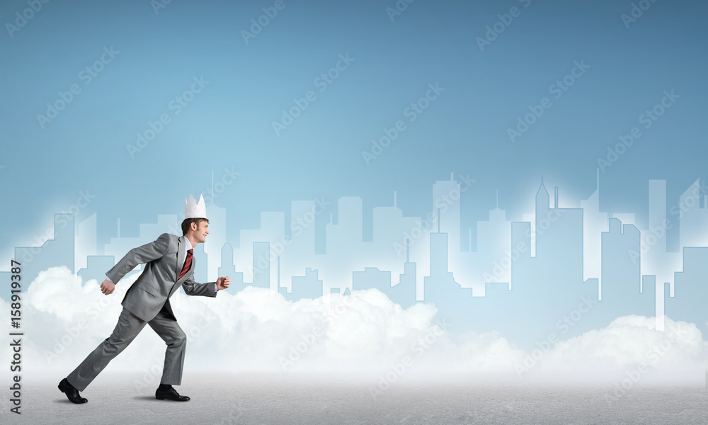 King businessman in elegant suit running and blue cityscape silhouette at background King businessman in elegant suit running and blue cityscape silhouette at background