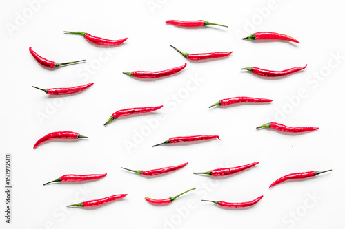 food ingredient red chilli pepper on white table background top view pattern