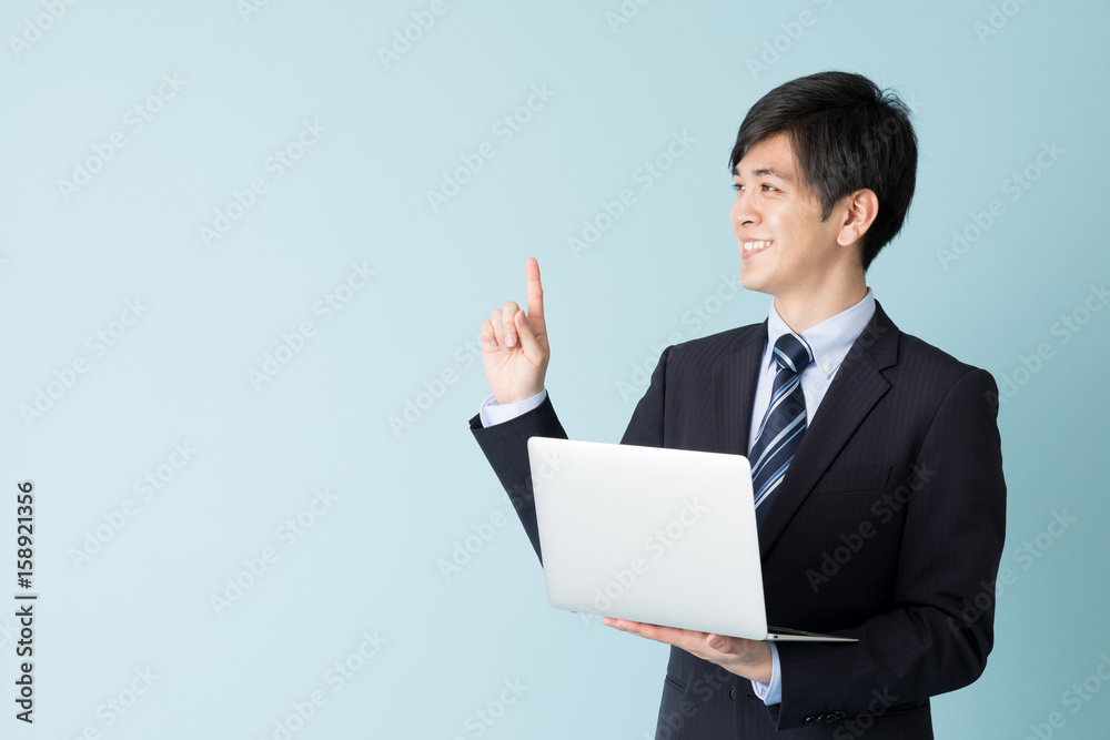 portrait of asian businessman isolated on blue background portrait of asian businessman isolated on blue background