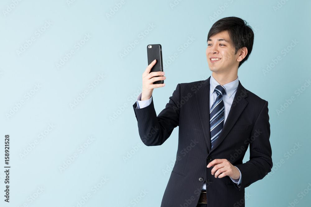 portrait of asian businessman isolated on blue background portrait of asian businessman isolated on blue background