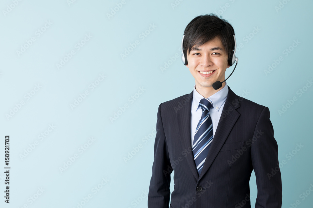 portrait of asian businessman isolated on blue background portrait of asian businessman isolated on blue background
