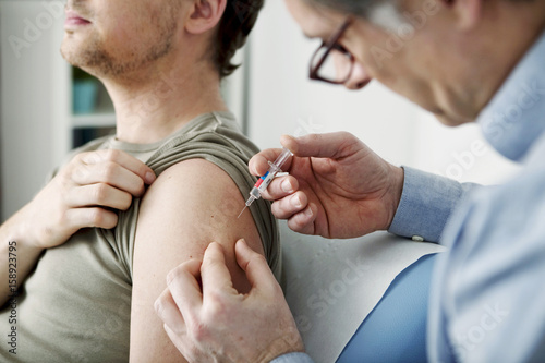 Vaccinating a man photo