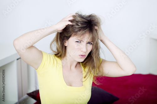 Woman scratching her head