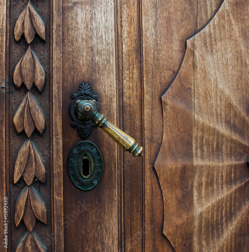 Old wooden door with iron handle on the Prešeren square in Ljubljana, Slovenia photo