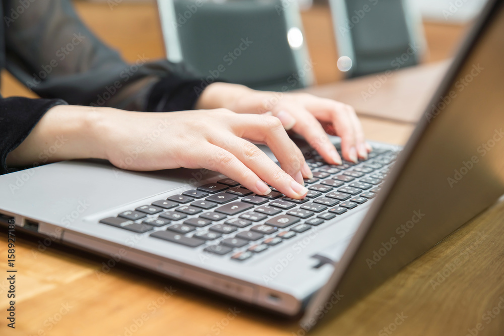 Businesswoman typing on laptop at workplace and working at office hand on keyboard close up Businesswoman typing on laptop at workplace and working at office hand on keyboard close up