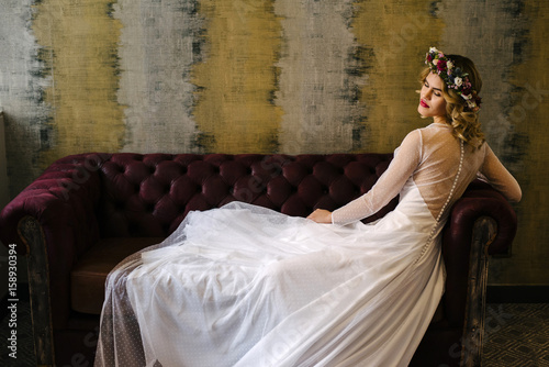 Elegant woman in flower chaplet and dress