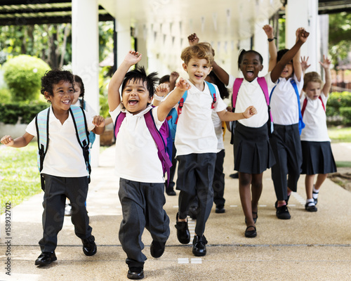 Group of diverse kindergarten students running cheerful after school