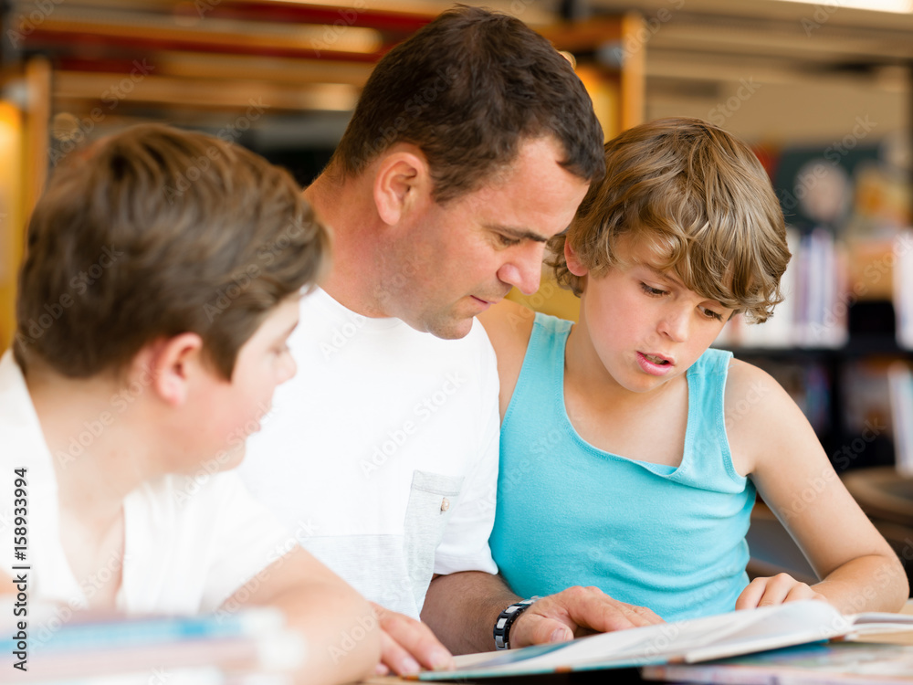 Father with sons in library Father with sons in library