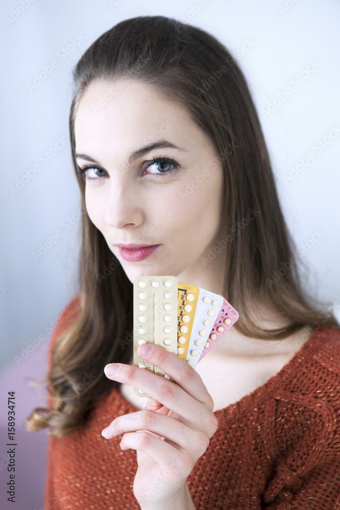 Woman holding contraceptive pills