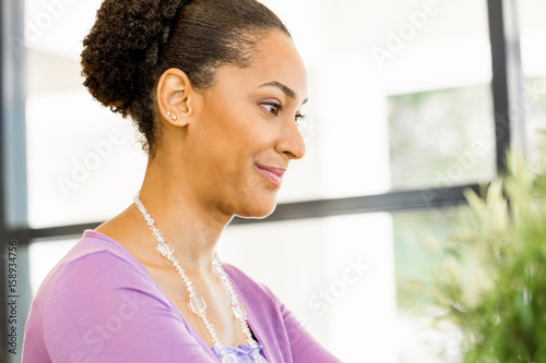 Portrait of smiling afro-american office worker sitting in offfice