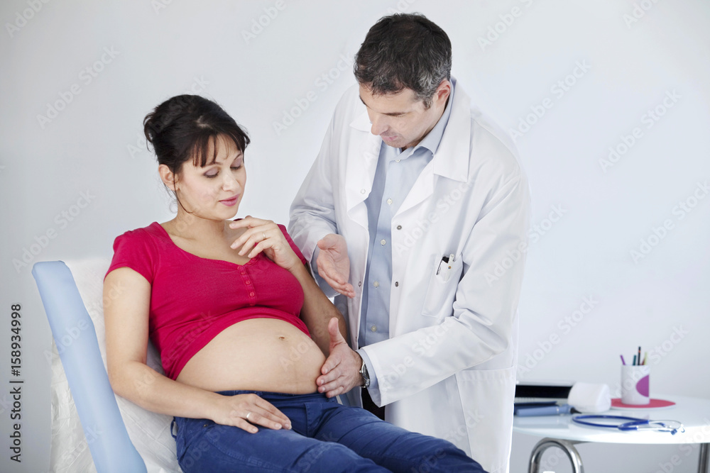 Fototapeta premium Abdomen palpation pregnant woman