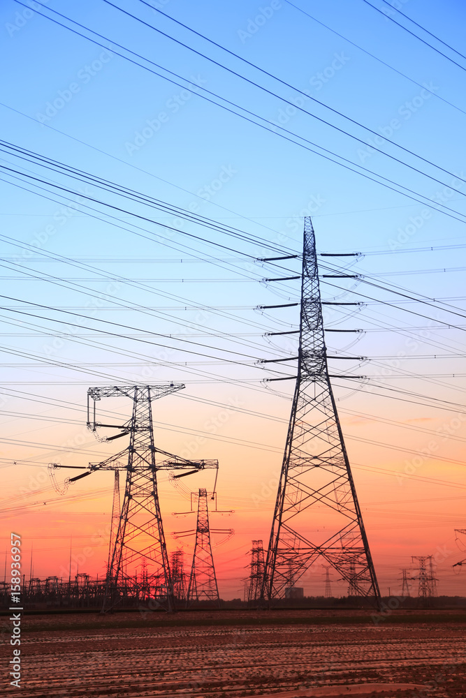 Fototapeta premium The silhouette of high voltage towers