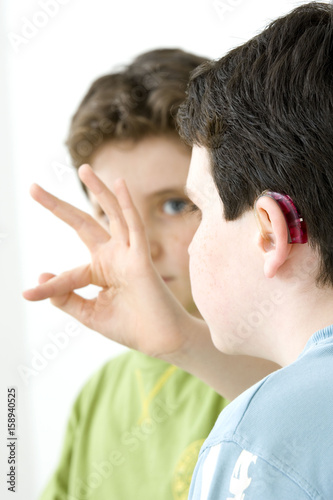 Models Do not use for HIV A young boy and his brother using the French sign language to discuss with his hearing-impaired brother The French sign language uses signs to designate words but also dactylology (each letter of the alphabet is represented by a defined position of the fingers then enabling to spell a word) and the lip reading The young boy designates the letter \f\ (see image nﾰ0833202 and series of images from nﾰ0572308 to 0573508 to see the other letters of the alphabet)