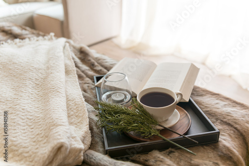 Coffee and book on the bed with window light in the morning 