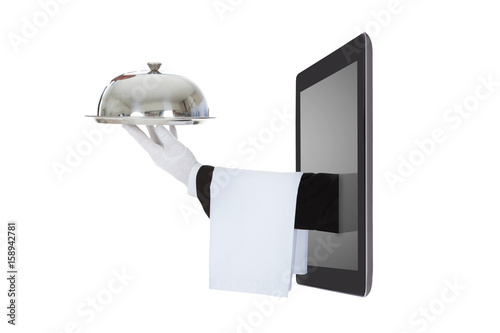 Waiter's Hand Coming Out From The Digital Tablet