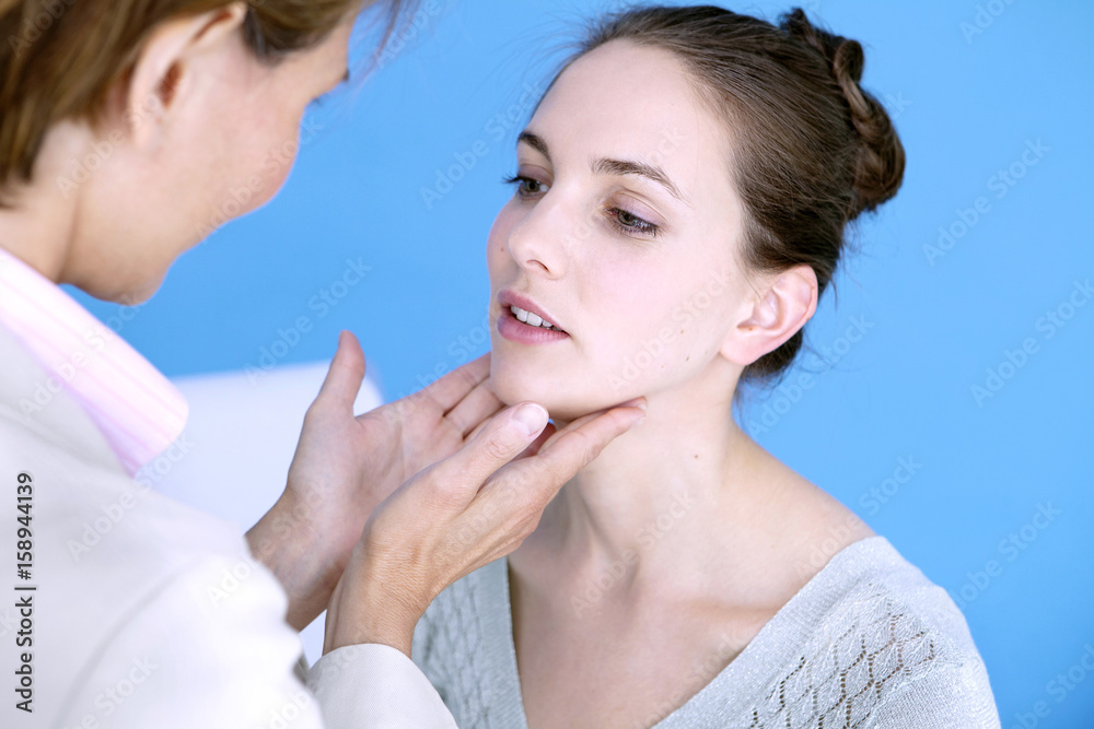 Doctor palpating the lymphatic nodes of a patient Doctor palpating the lymphatic nodes of a patient