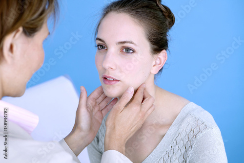 Photos Doctor palpating the lymphatic nodes of a patient