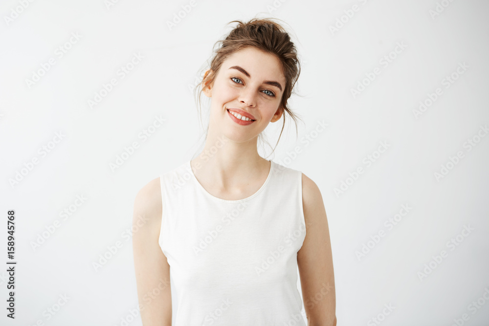 Portrait of young beautiful brunette girl smiling looking at camera over white background. Portrait of young beautiful brunette girl smiling looking at camera over white background.