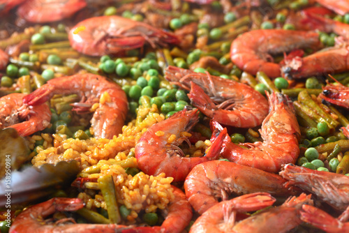Paella with seafood and chicken. Prepared in wok.