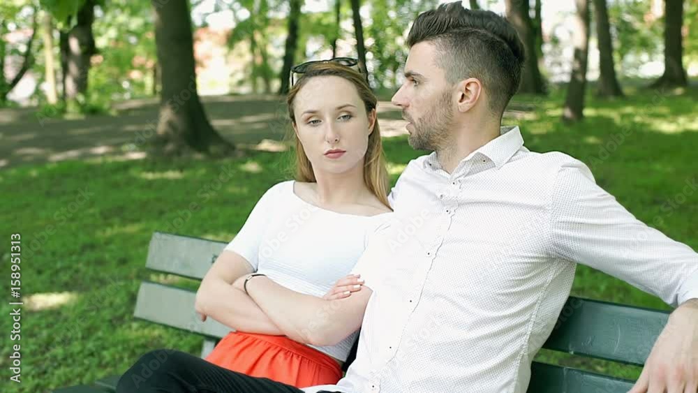 Lovely couple sitting on the bench in the park and smiling to the camera, steadycam shot
Lovely couple sitting on the bench in the park and smiling to the camera, steadycam shot