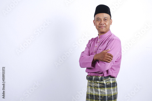 Man in traditional clothing, standing celebrate Eid Fitr.