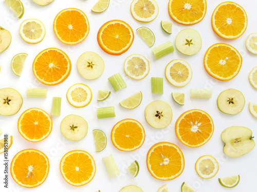 Orange slices and apples on a white background. Fruit pattern. Abstract food background. Top view. © Tatiana Morozova