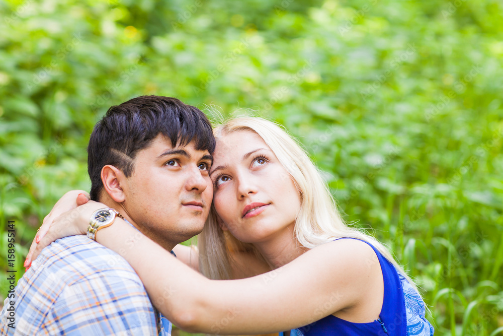 summer holidays, love, romance and people concept - happy loving couple hugging outdoors