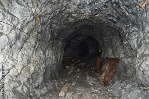 an abandoned mine tunnel in the mountains, stone catacombs