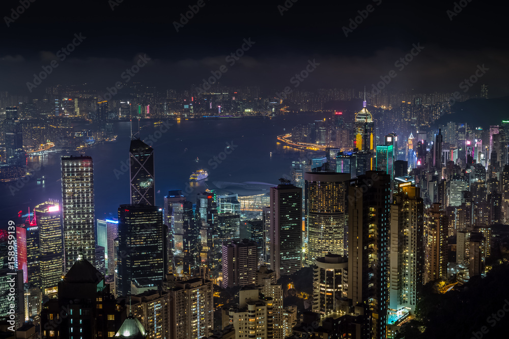 Aerial night view from Victoria peak to Kowloon bay and skyscrapers of Hong Kong island, China republic