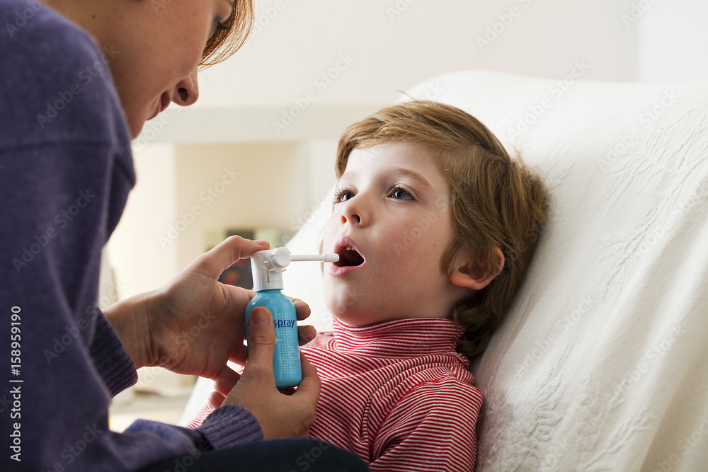 Child using spray in mouth Child using spray in mouth
