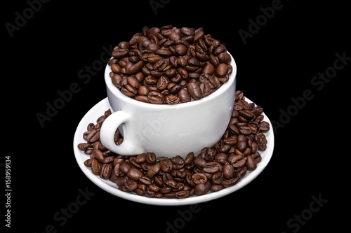 White coffee mug full of coffe beans.