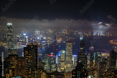 Aerial night view from Victoria peak to Kowloon bay and illuminated skyscrapers of Hong Kong island  China republic