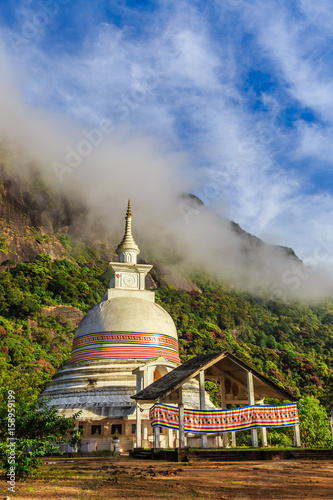 Buddist stupa with green mountains and blue sky, on the way to the top of Adam's peak, Sri Lanka