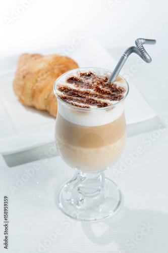 Glass of cold latte coffee topic cocolate cream on isolated white background with desserts