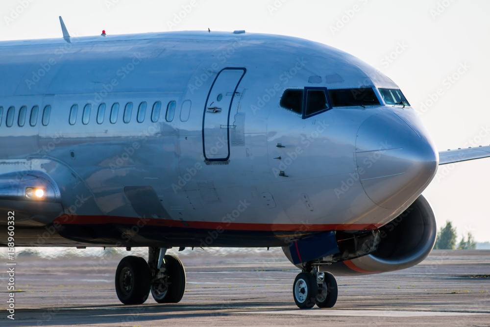 Obraz premium Close-up the front of the passenger plane taxiing on the airport apron