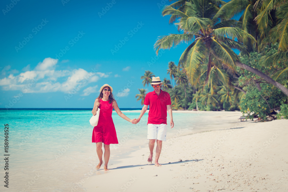 happy loving couple walk on beach