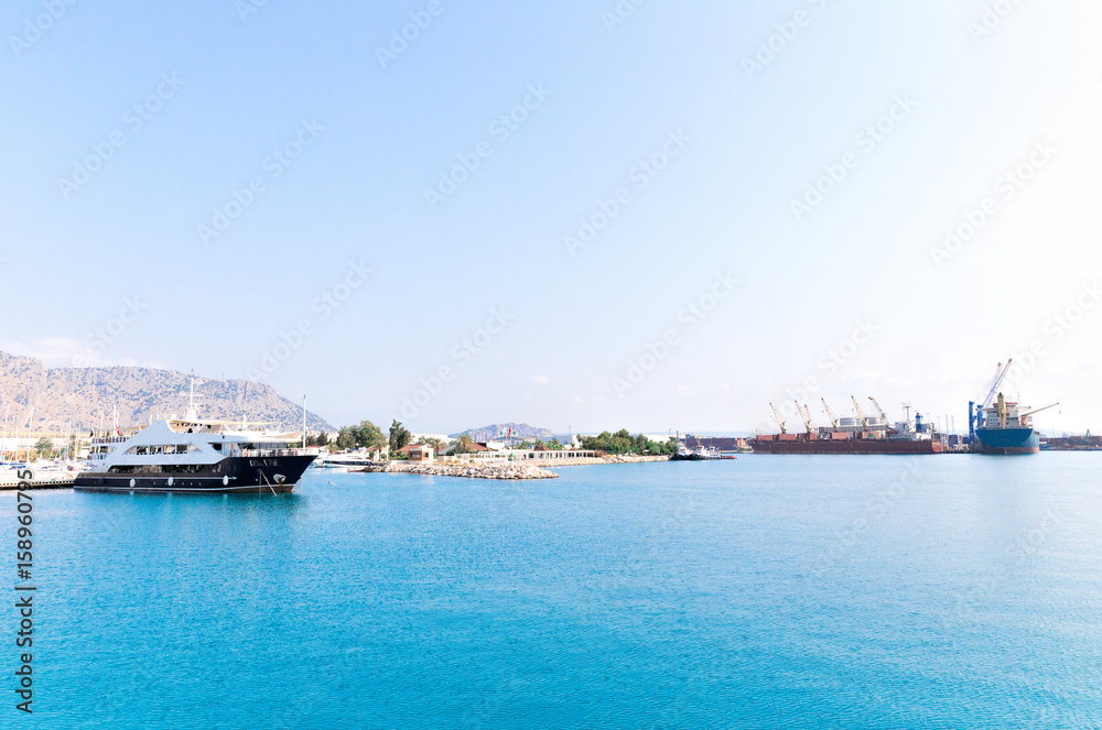 Yachts, pleasure boats and container ships in the port