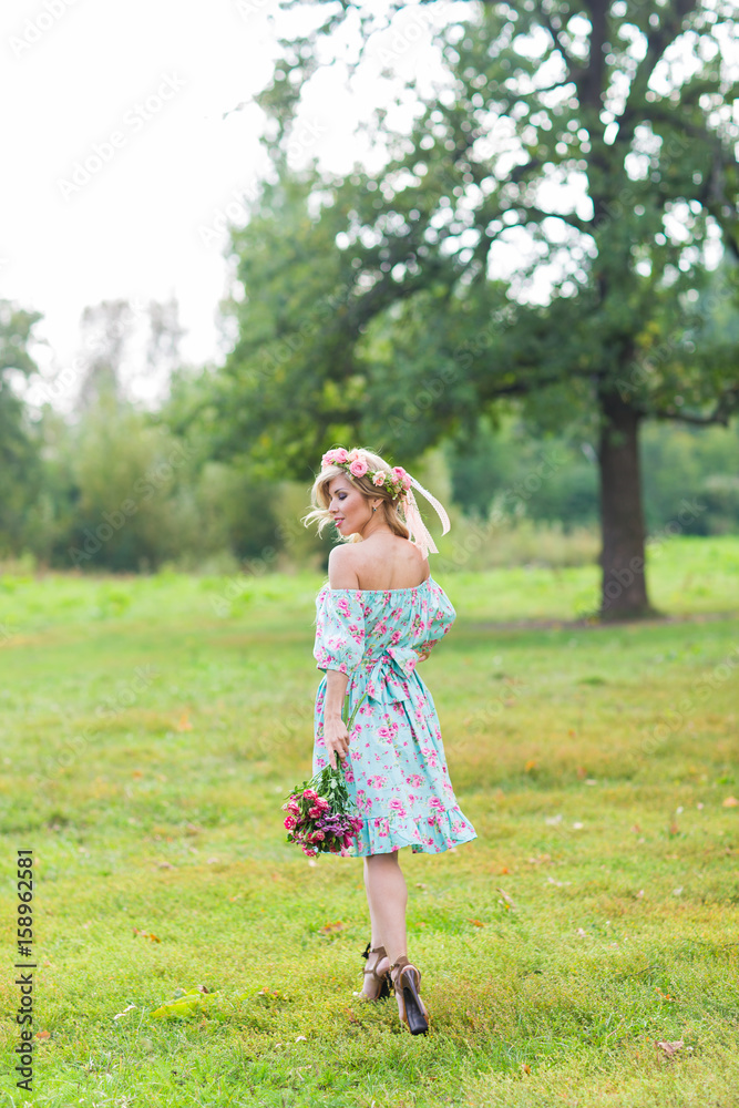 Portrait of the young beautiful romantic woman in dress outdoors Portrait of the young beautiful romantic woman in dress outdoors