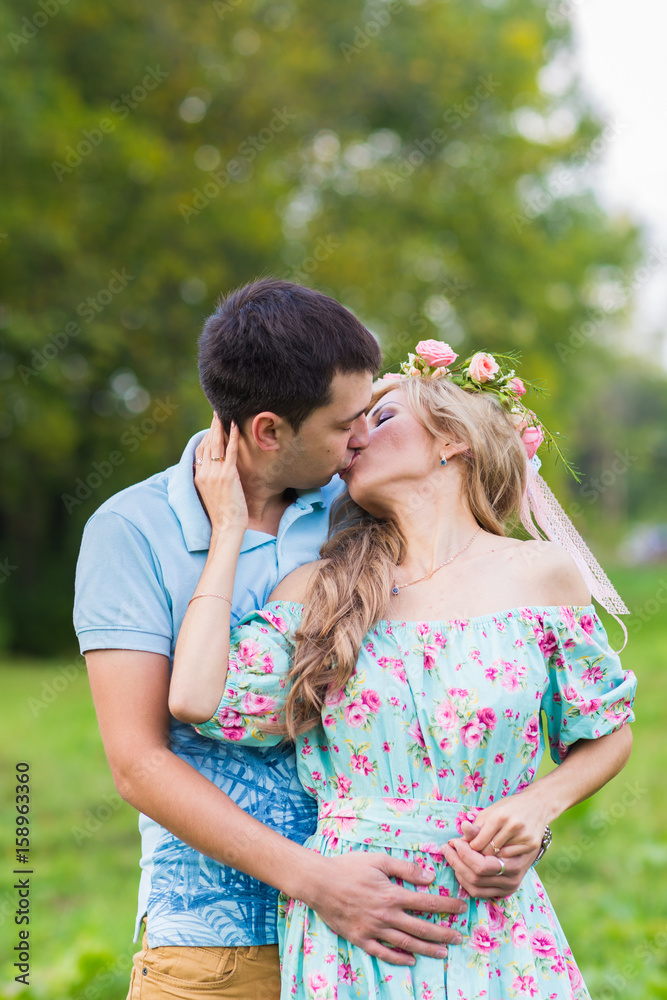 happy young couple kissing and hugging on nature happy young couple kissing and hugging on nature