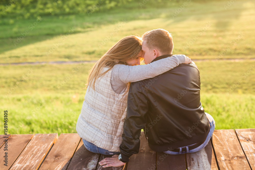 couple hugging on a pier in nature back view couple hugging on a pier in nature back view