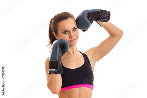 Portrait of a young girl in a sports top and boxing gloves