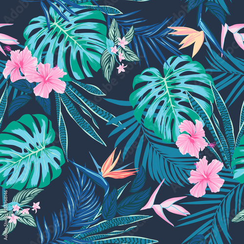Vector seamless tropical pattern, vivid tropic foliage, with monstera leaf, palm leaves, bird of paradise flower, hibiscus in bloom. modern bright summer print design