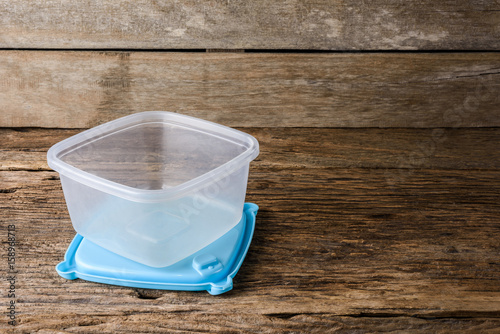 Empty containers for food on wooden background