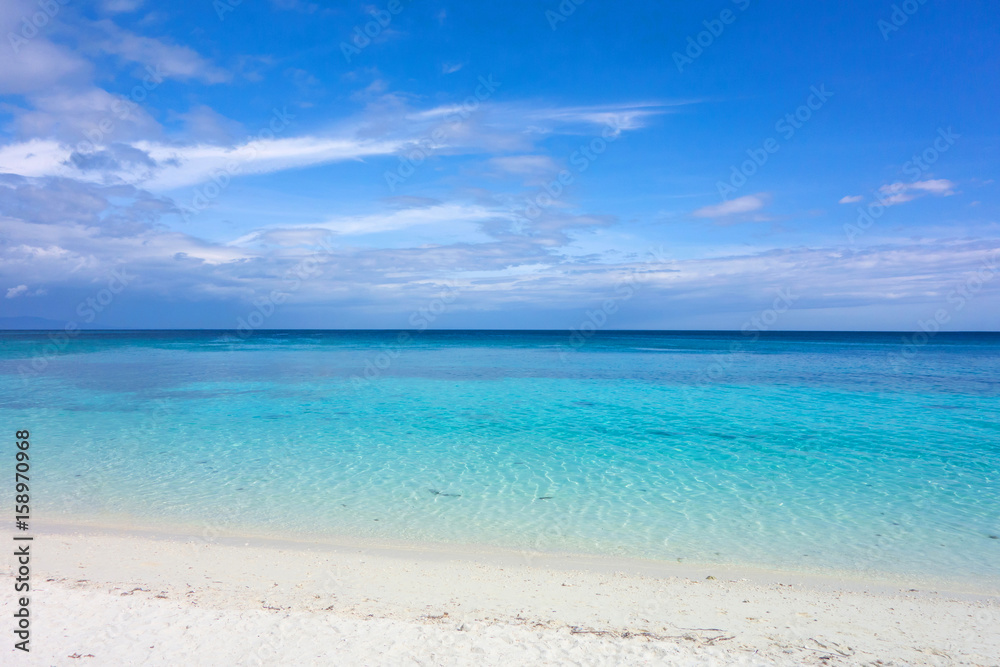 White clouds with blue sky over calm sea. Clear blue water with fantastic white sand beach. Summer outdoor nature holiday serenity. Kalanggaman Island, Philippines. Background, copy space.