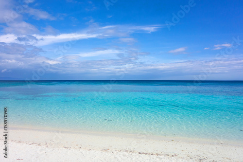 White clouds with blue sky over calm sea. Clear blue water with fantastic white sand beach. Summer outdoor nature holiday serenity. Kalanggaman Island  Philippines. Background  copy space.